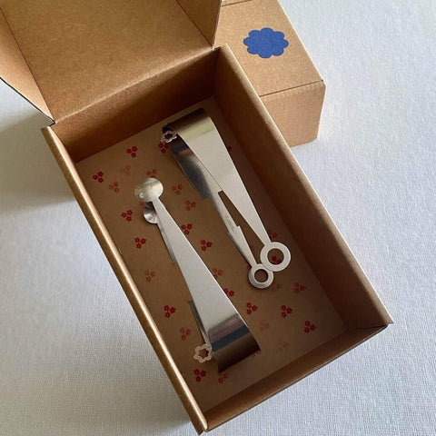 Set of two stainless steel serving tongs in dome and circle design in brown gift box with hand stamped floral pattern