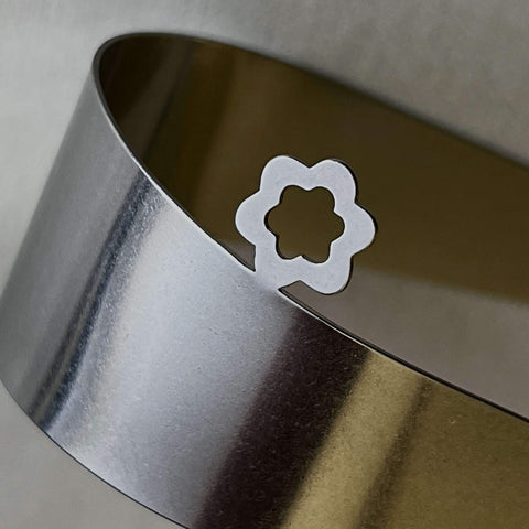 Close up detail of flower design on between you and me stainless steel serving tongs