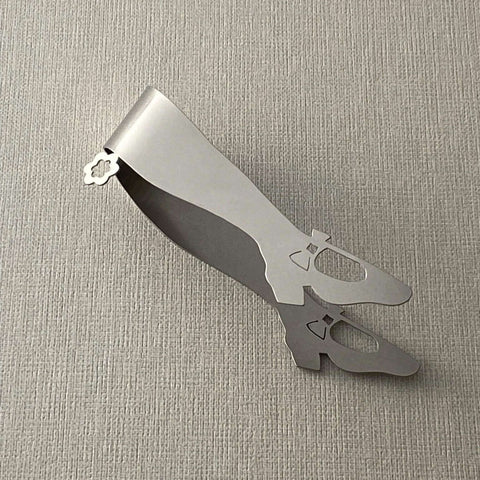 Stainless steel mini tongs lying on side on grey background
