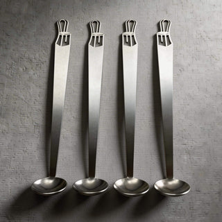 Set of Bentwood stainless steel tiny serving ladles on a textured grey surface