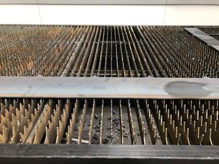 Stainless steel sheet on laser cutting bed during the Between You and Me production process