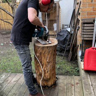 Studio maker cutting timber outdoors as part of the handcrafted production process