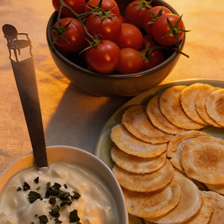 Cabriole stainless steel tiny serving ladle styled with cherry tomatoes, crackers and dip