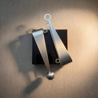 Handcrafted stainless steel Dome and Circles serving pair resting on a dark brown table tile