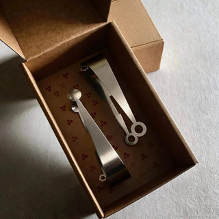 Dome and Circles stainless steel serving pair presented in a hand-stamped kraft gift box