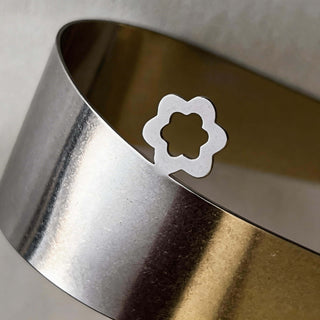 Close up of handcrafted stainless steel Domes server highlighting flower detail