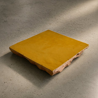 Golden Sun handcrafted ceramic table tile showing warm ochre glaze and raw clay edge