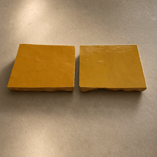 Pair of Golden Sun handcrafted ceramic table tiles with warm glazed finish and natural textured edges