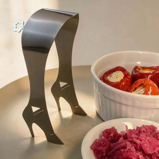 Stainless steel High Heel serving piece beside dishes of antipasto and pickled vegetables