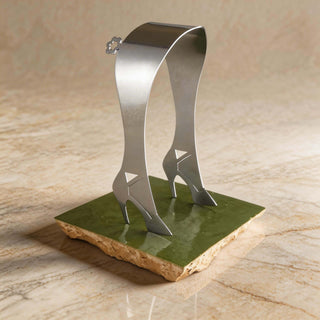 Pair of handcrafted stainless steel High Heel servers standing on a handmade green tile