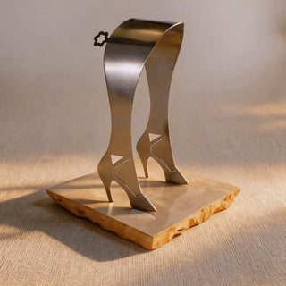 Pair of handcrafted stainless steel High Heel servers on handmade cream tile