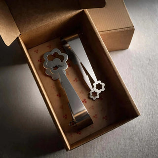 Kaleidoscope and Flowers stainless steel serving pair presented in a hand-stamped kraft gift box
