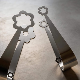 Handcrafted stainless steel Kaleidoscope and Flowers serving pair on a grey stone surface