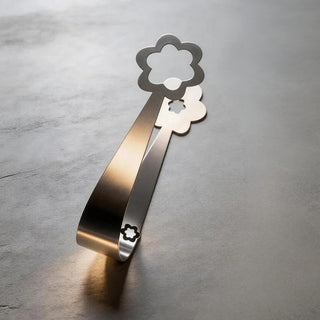 Handcrafted stainless steel Kaleidoscope serving piece on dark stone surface