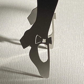 Close-up of pointed shoe detail on handcrafted stainless steel Off to See the Wizard serving piece