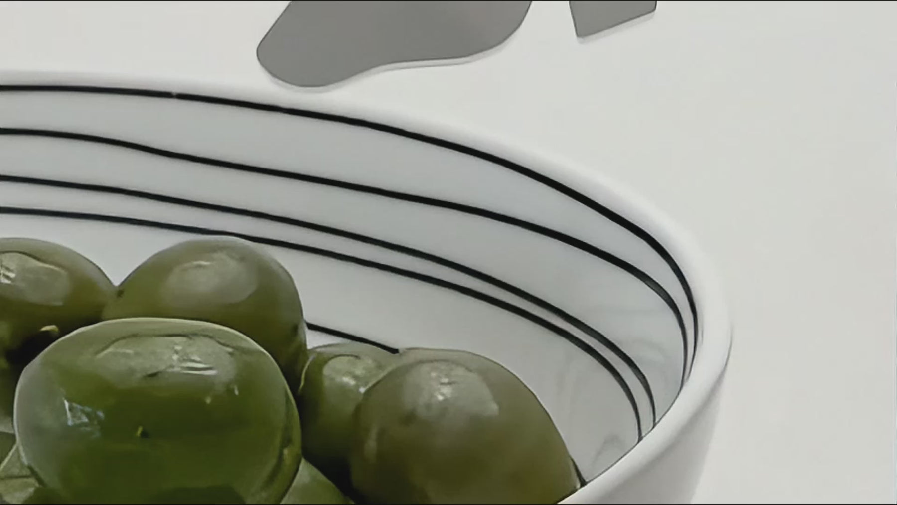 Home page video featuring handcrafted stainless steel serving pieces, cocktail picks and table objects styled with olives, drinks and soft light.