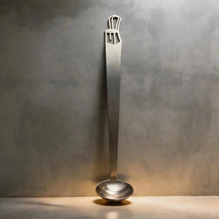 Single Bentwood stainless steel tiny serving ladle on a grey stone surface