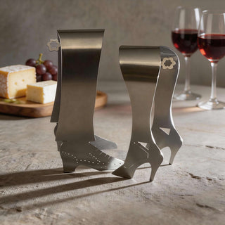 Handcrafted stainless steel Stepping Out serving pair styled beside cheese board, grapes and red wine glasses