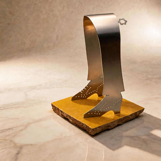 Pair of handcrafted stainless steel Tap Shoe servers standing on a handmade yellow tile